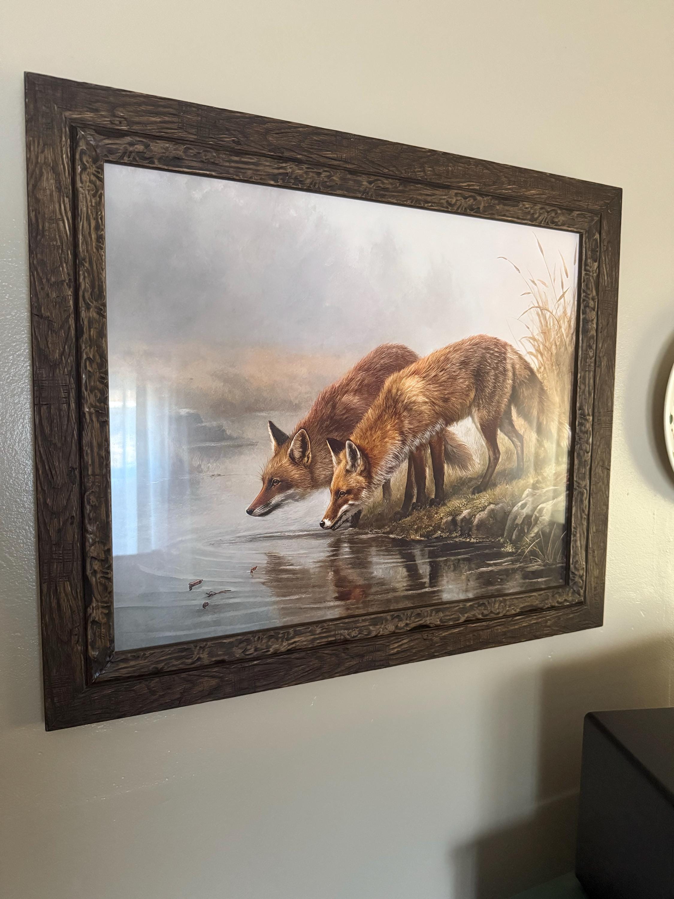 Customer photo: Two foxes at a mountain stream at golden hour hanging in a real home